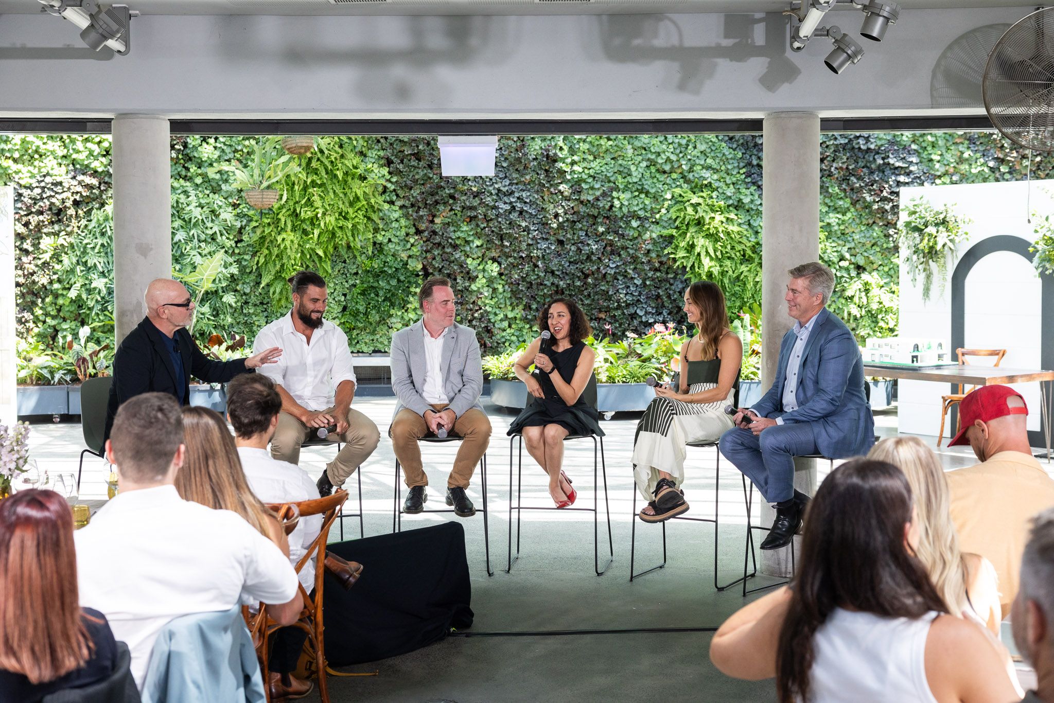 A panel of experts explores key insights from the Modern Homes Forecast 2025, sharing perspectives on emerging home design trends in front of an engaged audience.